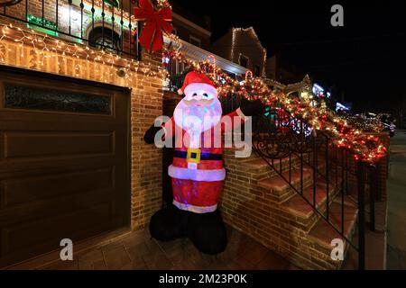 Santa Claud waved in the driveway of a home in the Dyker Heights section of Brooklyn, New York on Monday, Dec. 12, 2022. (Photo: Gordon Donovan) Stock Photo