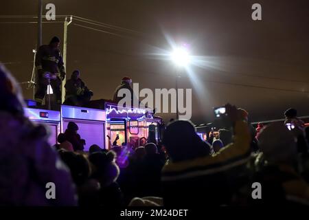 A crowd of people and firefighters on a fire truck watch the arrival of the Canadian Pacific holiday train Holds a benefit concert for various charity Stock Photo