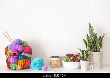 Cozy homely atmosphere. Female hobby knitting and Crochet. Yarn multicolor in a basket.  Stock Photo