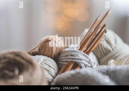 Cozy homely atmosphere. Female hobby knitting. Yarn in neutral colors. Stock Photo