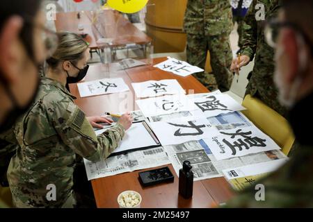 Japan. 1st Dec, 2022. Members of the Yama Sakura exercise learn 'kanji', traditional Japanese calligraphy, during the Friendship Event Cultural Exchange night at the Higashi Kosei Center on Camp Higashi-Chitose, Japan, Decemberember 1, 2022. Yama Sakura is a bilateral U.S. Army and Japan Ground Self Defense Force exercise that promotes the unwavering U.S.-Japan relationship. Credit: U.S. Army/ZUMA Press Wire Service/ZUMAPRESS.com/Alamy Live News Stock Photo