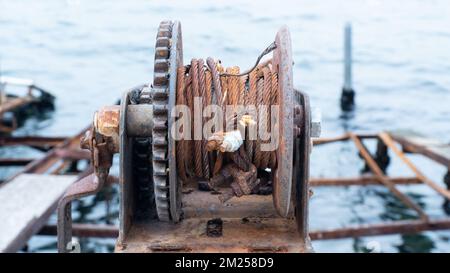 Rusty chains and rope. rope winding machine. nautical instruments ...