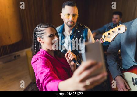 let's show everybody how our repetition is going, music band playing on repetition and recording live video at the same time. High quality photo Stock Photo