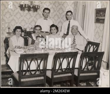 Changelian family. Gladys, Paul. George, his wife [Anahid] and baby Esther. Charles, his wife , Families, Dining tables, Infants.  Leon Abdalian Collection Stock Photo