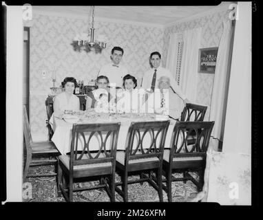 Changelian family. Gladys, Paul. George, his wife [Anahid] and baby Esther. Charles, his wife , Families, Dining tables, Infants.  Leon Abdalian Collection Stock Photo