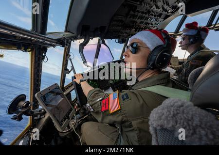 Saipan, United States. 01 December, 2022. U.S. Air Force C-130J pilots, Capt. Maddie Atkinson, left, and Capt. Eichard Armfield, maneuver the aircraft into position during Operation Christmas Drop 2022, December 1, 2022 in Saipan, Northern Mariana Islands. Operation Christmas Drop is the oldest humanitarian and disaster relief mission delivering 71,000 pounds of food, gifts, and supplies to assist remote island communities in the South Pacific.  Credit: Yasuo Osakabe/US Airforce Photo/Alamy Live News Stock Photo