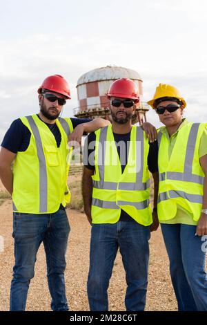 Portrait of three industrial workers standing on a construction site Stock Photo