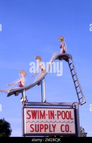 Pool Slides Sign Pool Supply sign depicting a woman on a pool slide, Inglewood, CA Stock ...