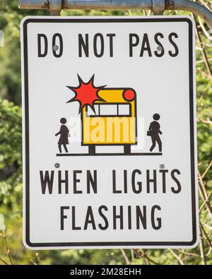 Do not pass school bus sign at the highway junction in Hope, British Columbia, Canada Stock Photo