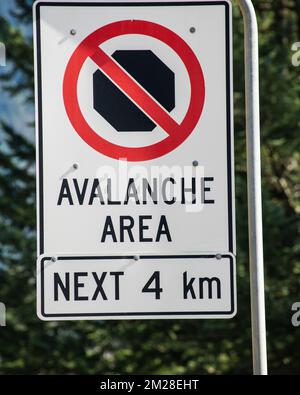 Avalanche area sign at the highway junction in Hope, British Columbia, Canada Stock Photo