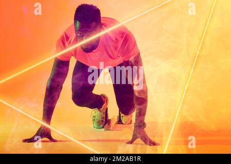 African american male athlete at starting position by illuminated triangle over gradient background Stock Photo