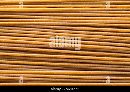 Pile of Wheat Spaghetti Noodles Background Close Up. Stock Photo