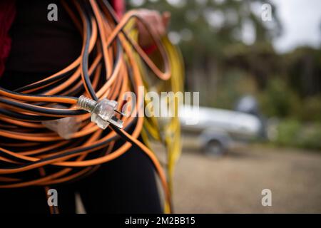 power lead on a building site, electrician with a power cable outside Stock Photo