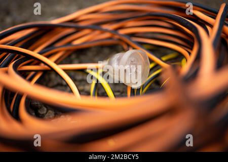 power lead on a building site, electrician with a power cable outside Stock Photo