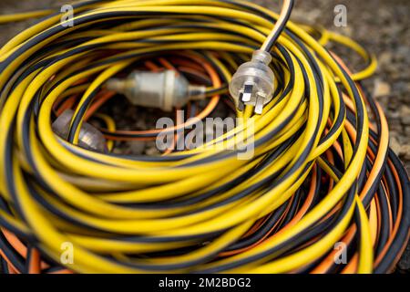 power lead on a building site, electrician with a power cable outside Stock Photo