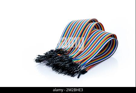 Ribbon cable or multi-wire planar cable on white background. Flat ribbon cable with pin connectors. Multi-colored ribbon computer connecting cable. Stock Photo