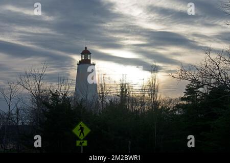 Sandy Hook Lighthouse silhouette against a mostly cloudy sky at sunset -79 Stock Photo