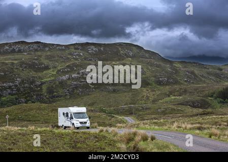 Motorhome / campervan driving along winding single track road with passing places in the Scottish Highlands, Ross-shire, Scotland, UK | Camping-car / autocaravane en route dans Ross-shire, Ecosse, Royaume-Uni 30/05/2017 Stock Photo