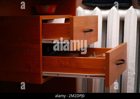 Open drawers of a wooden desk Stock Photo