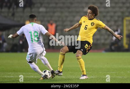 Saudi Arabia's midfielder Salem Al-Dawsari and Belgium's Axel Witsel fight for the ball during a friendly game between the Red Devils Belgian National soccer team and Saudi Arabia, in Brussels, Tuesday 27 March 2018. BELGA PHOTO VIRGINIE LEFOUR Stock Photo