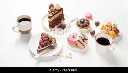 Table with various cookies, donuts, cakes, cheesecakes and coffee cups on white background.  Delicious dessert table. Stock Photo