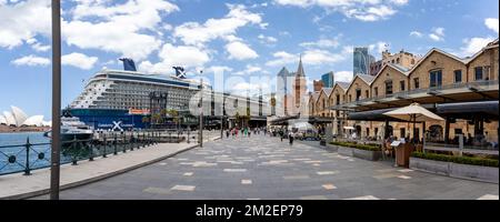 CPanoramic view of Cruise Ship docked at Sydney Cruise Terminal with old warehouses and skyscrappers in Sydney, Australia on 9 December 2022 Stock Photo