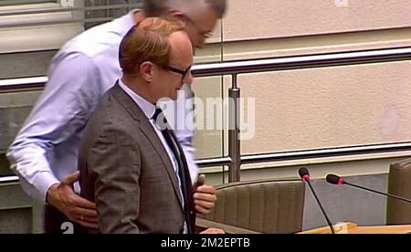 This screengrab, taken from the Flemish Parliament live streaming, shows Flemish Minister of Mobility, Public Works, Flemish municipalities around Brussels, Animal Welfare Ben Weyts feeling unwell during a plenary session of the Flemish Parliament in Brussels, Wednesday 25 April 2018. BELGA PHOTO HANDOUT  Stock Photo