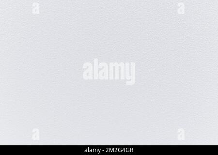 Plastered concrete or stone stucco wall painted in white, front view. High resolution full frame textured background. Copy space. Stock Photo