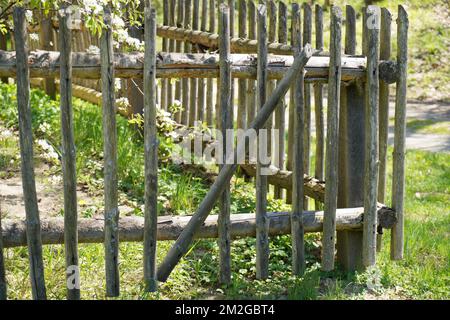 Wooden parts like windows, doors, roof and walls on an old house with a garden Stock Photo