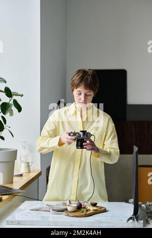 Professional photographer doing close-up pictures of still life using her photo camera Stock Photo