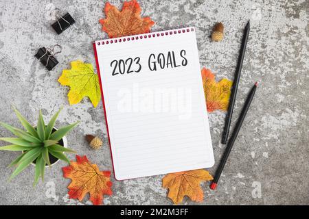 Notebook with 2023 goals written on it to make new plans in the new year Stock Photo
