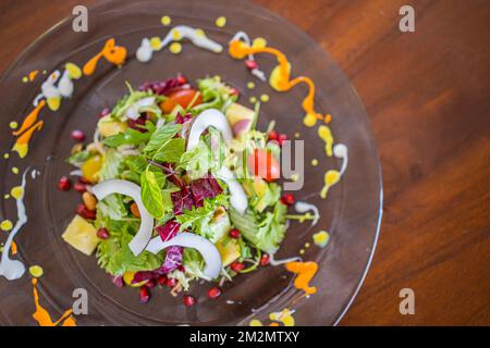 Gourmet spicy vegetarian stew with chickpeas and vegetables on plate close up, healthy vegetarian food on wooden background. Resort hotel luxury India Stock Photo