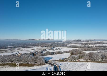 Aerial drone photo of the town of Mereclough in the town of Burnley in Lancashire, England showing the farmers fields on a snowy winters day in the UK Stock Photo