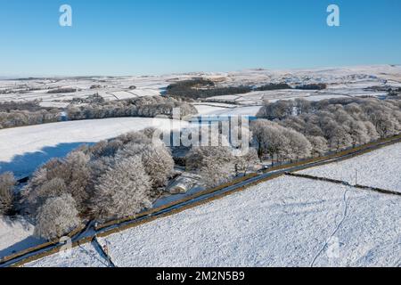 Aerial drone photo of the town of Mereclough in the town of Burnley in Lancashire, England showing the farmers fields on a snowy winters day in the UK Stock Photo