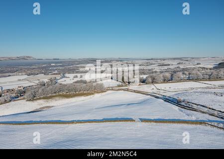 Aerial drone photo of the town of Mereclough in the town of Burnley in Lancashire, England showing the farmers fields on a snowy winters day in the UK Stock Photo