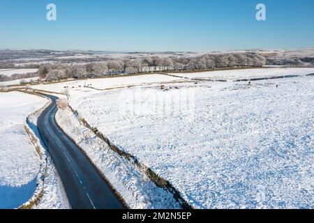 Aerial drone photo of the town of Mereclough in the town of Burnley in Lancashire, England showing the farmers fields on a snowy winters day in the UK Stock Photo