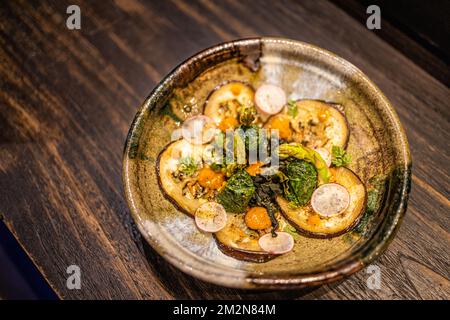 Grilled colorful vegetables, auberges, zucchini, pepper with spice and green basil on serving board on white background, top view. Artistic luxury Stock Photo