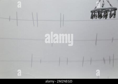 shadow on the wall of clothesline and clothespins Stock Photo