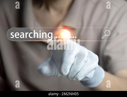 Searching information concept. Hand of man touching in icon search Stock Photo