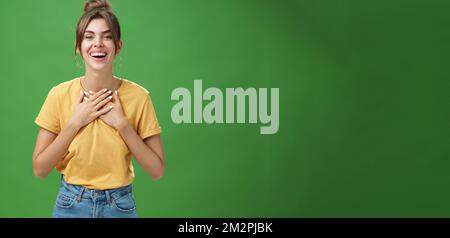 Delighted charming woman with gapped teeth in cozy outfit holding palms on  chest in grateful or thankful pose smiling broadly receiving warm Stock  Photo - Alamy
