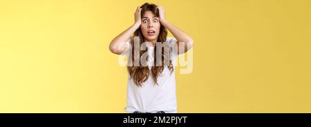 Troubled concerned anxious panicking woman female employee lose control grab head nervously stare camera frustrated scared gasping hopeless puzzled Stock Photo