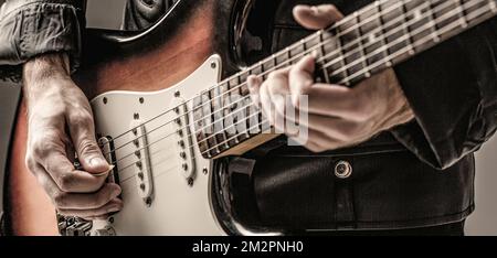 Man playing guitar. Close up hand playing guitar. Musician playing guitar, live music Stock Photo