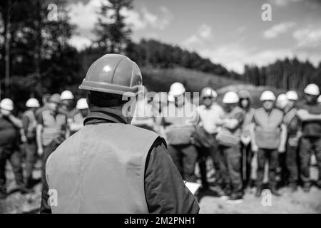 Building concept. Architector, engineers on constructing site. Builder man. Black and white Stock Photo
