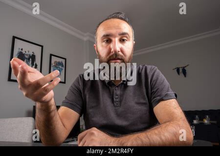 Young business man working from home web cam view. Talk on notebook camera having video call or conversation with client, virtual distance meeting. Stock Photo