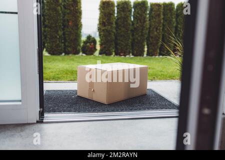 View from inside out, package sitting at the front door waiting to be picked up  Stock Photo