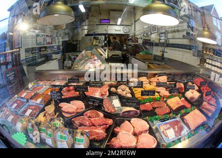 Wide-angle shot of traditional butcher's window display of meat for sale. Salisbury. UK 2022. Stock Photo