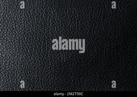 Texture of Black leather with shadow as background. Stock Photo