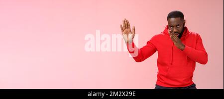 Guy knows asian fighting skills. Portrait serious-looking funny african-american young man perform martial arts standing kung-fu karate pose raised Stock Photo