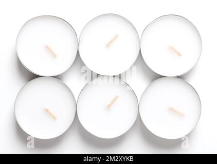 Group of maxi tealights, long-burning tea lights, large tea candles, also known as nightlights. Tea lites, t-lites or t-candles in thin metal cups. Stock Photo