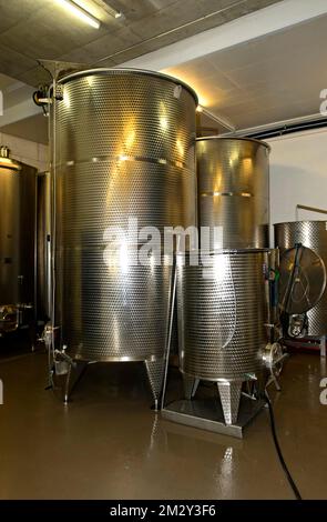 Stainless steel tanks for the fermentation of wine in the St Jodern winery, Heidi village Visperterminen, Valais, Switzerland